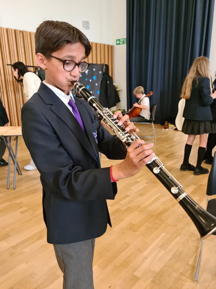 Student playing musical instrument