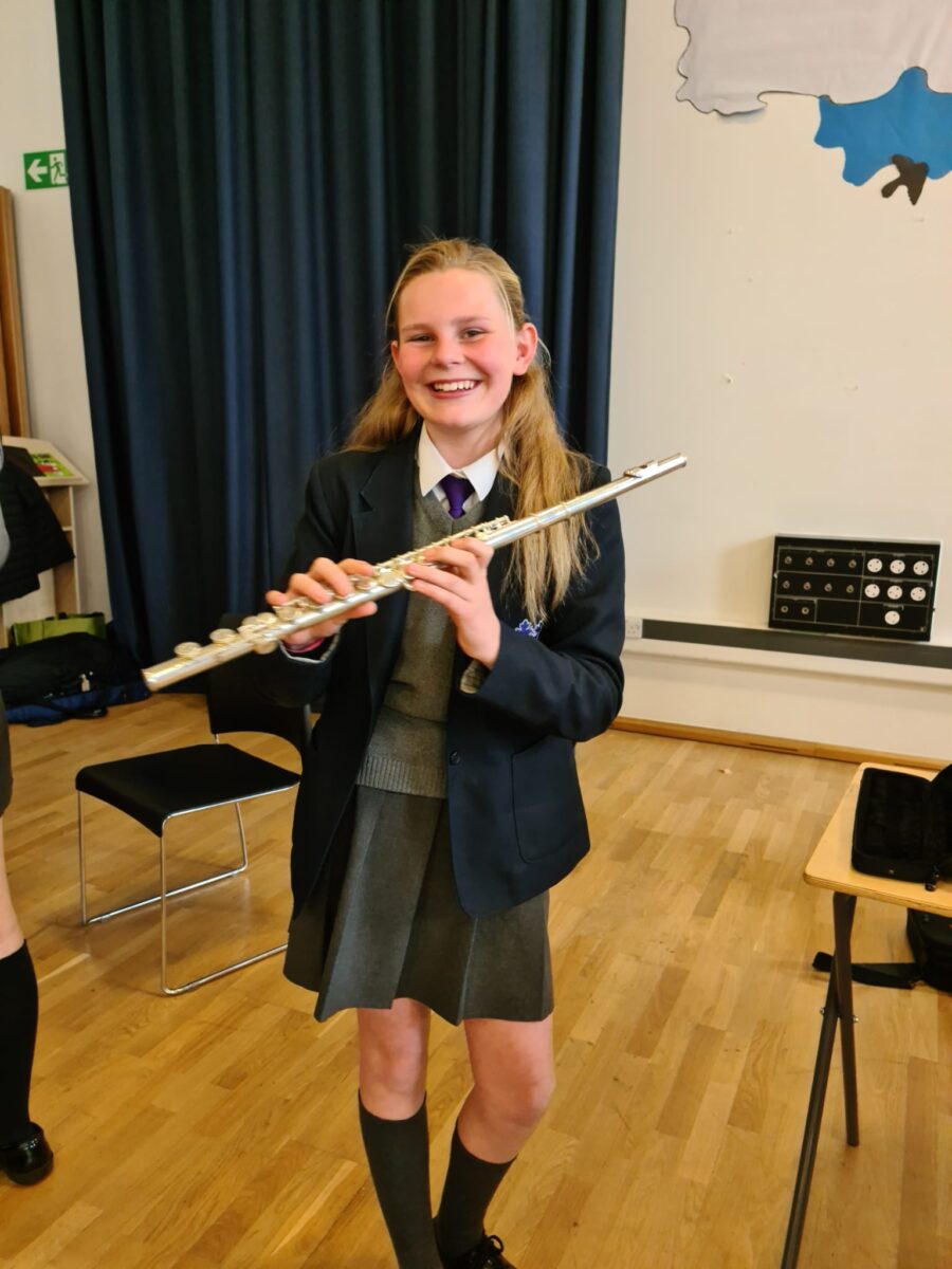 Student playing musical instrument