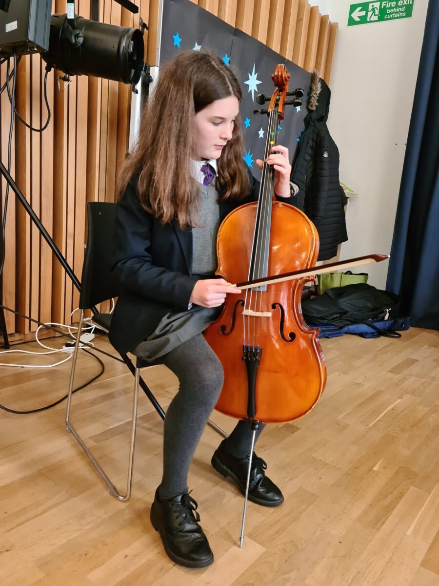 Student playing musical instrument