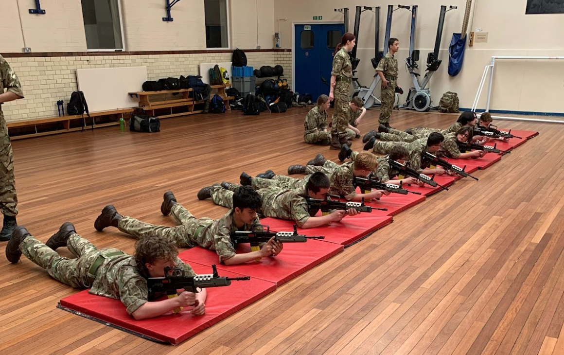 Cadets lying on the floor with prop guns