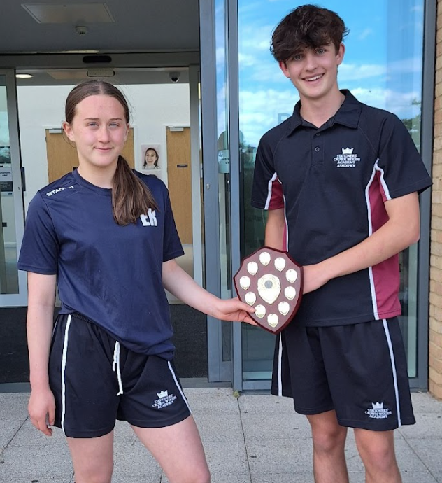 Students stood holding a trophy