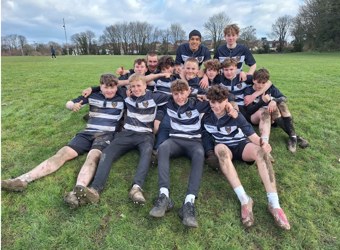 Rugby players posing after a match