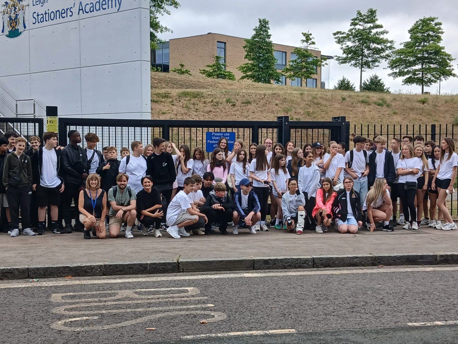 Pupils lined up outside of a school waiting to picked up