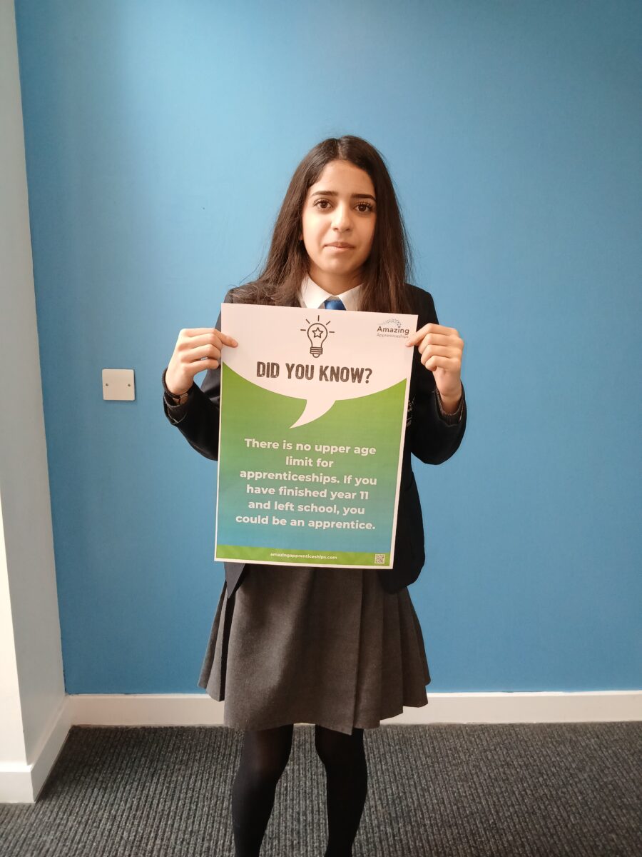 A student holding a poster