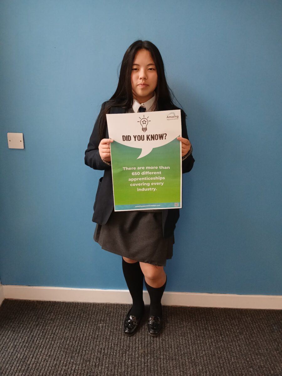 A student holding a poster