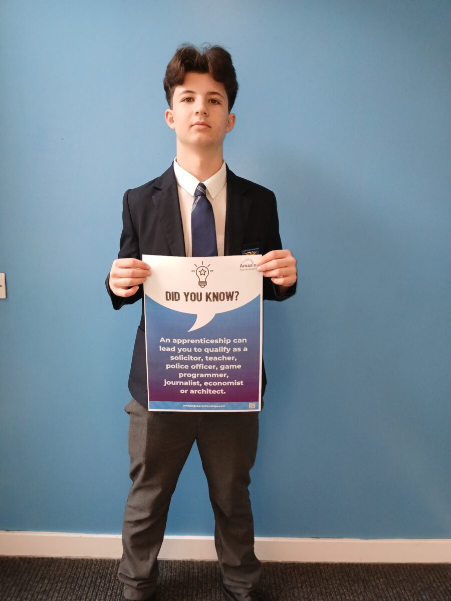 A student holding a poster