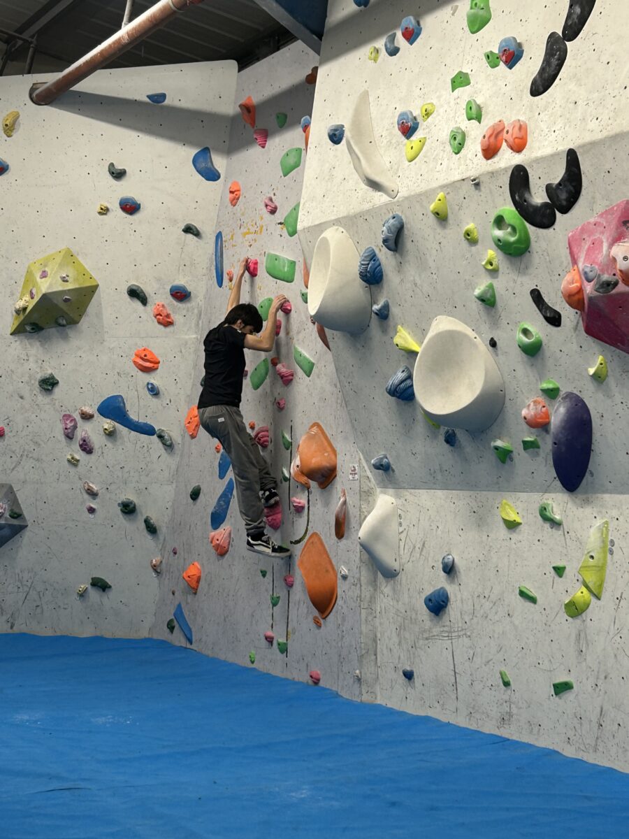 A youngster on an indoor climbing wall